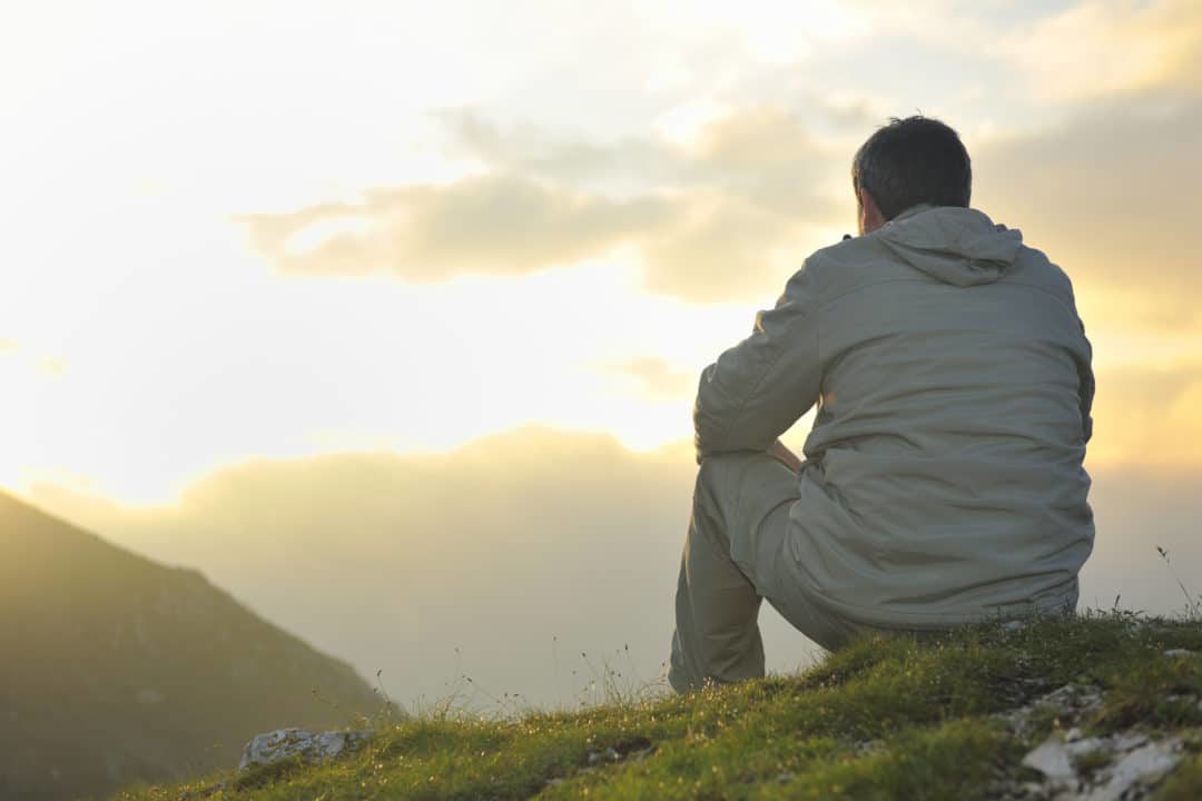 A person contemplating on a hill